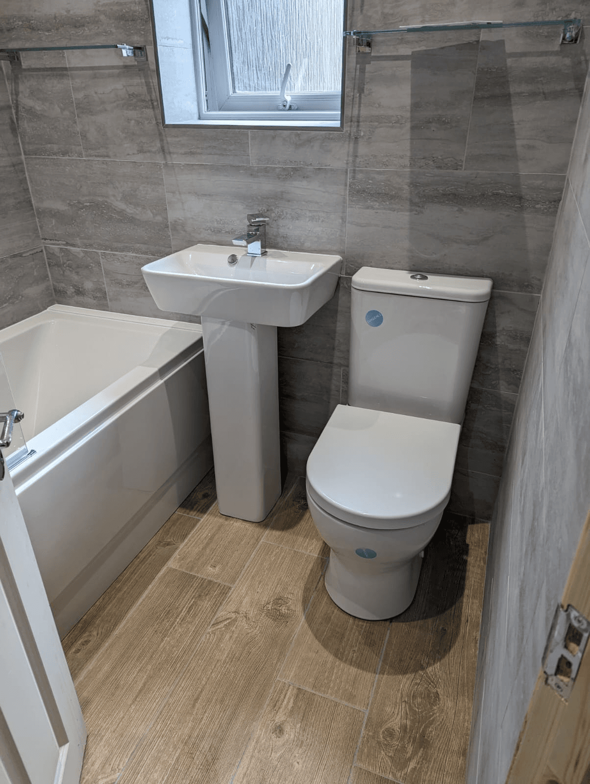 Complete bathroom suite with wood floor
