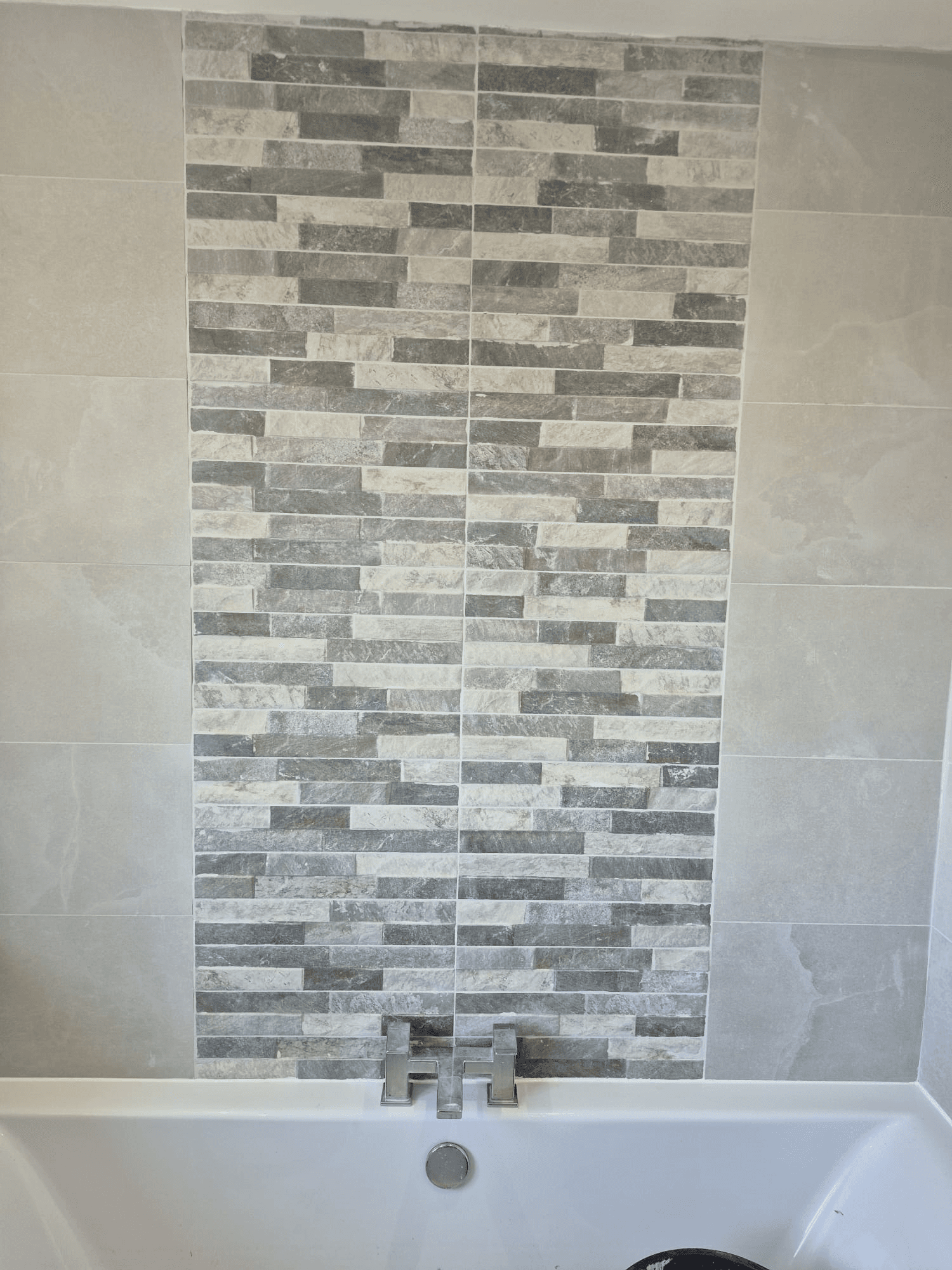 Mosaic splitface feature tile strip on bath surround