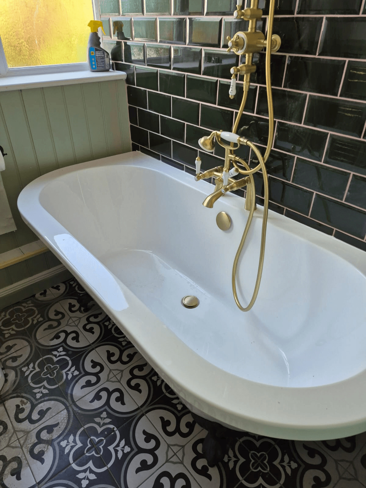 Luxury freestanding bath with brass taps installed by Deene's Bathrooms
