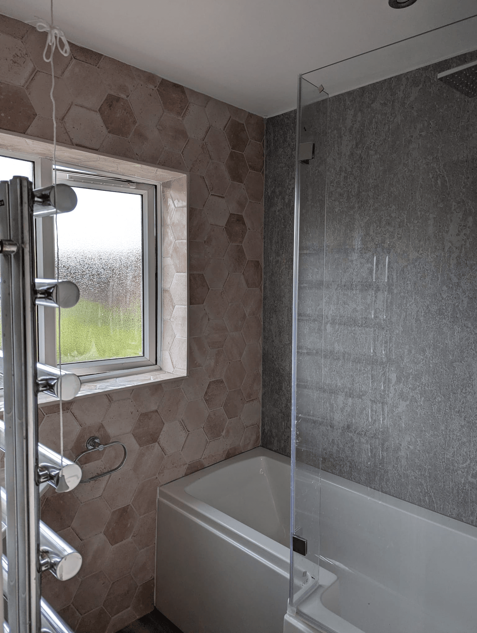 Blush pink hexagon tiles with bath screen